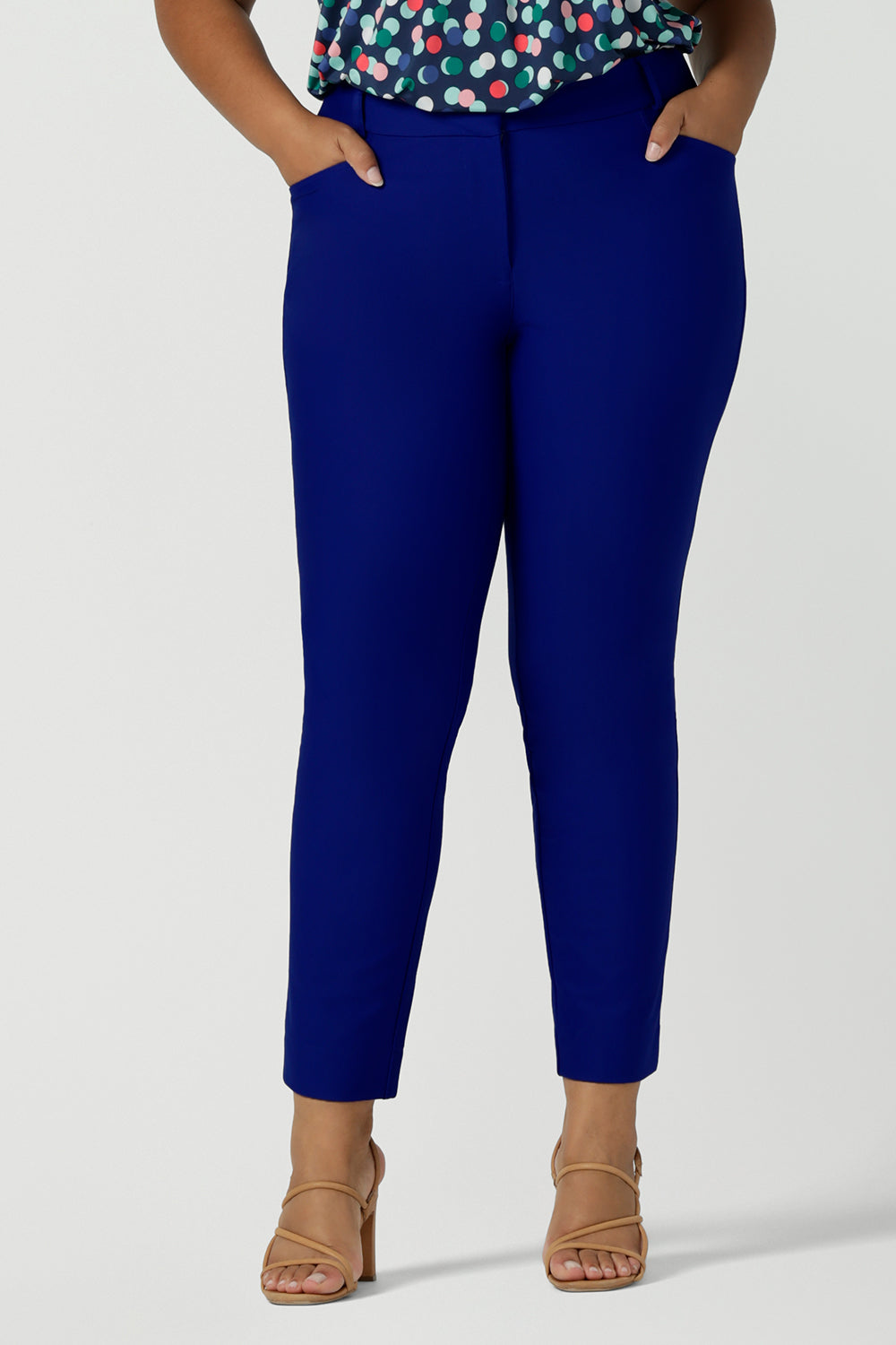 Cobalt blue tailored work pants in stretch ponte fabric are shown on size 18 woman. Great trousers for plus size women, these tailored work pants are made in Australia by women's clothing brand, Leina & Fleur and are available to shop online in sizes 8 to 24.