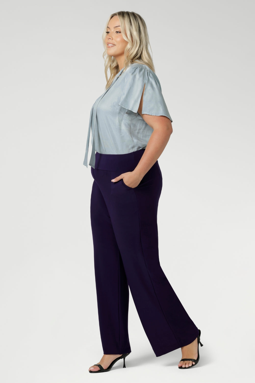 Made in Australia, these pull-on pants are available in three lengths, providing the perfect fit for various body types. The deep, double-layer waistband offers a smooth and flattering silhouette, while the side pockets with topstitching detail provide both functionality and a stylish touch. Stretchy workwear pants are available in sizes 8-24.