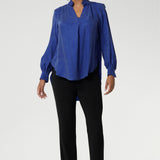 Over 30's woman wears black pants styles perfectly for back-to-work attire. These pants can easily be dressed up with a blouse and heels for an elevated look, or dressed down with a casual top and sneakers for effortless comfort. Australian made dry touch jersey fabric provides comfort in the work place and busy days.