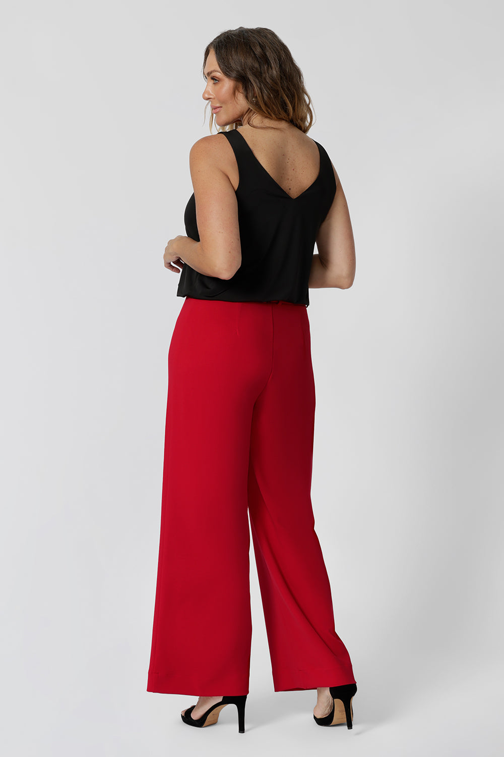 Back view of good pants for over 40s women, the Drew pant in red is a high waist pant with wide legs. Tailored belt loops and wide leg. Made in Australia for women. Stylish corporate wear for women. Made in Australia size 8 - 24.