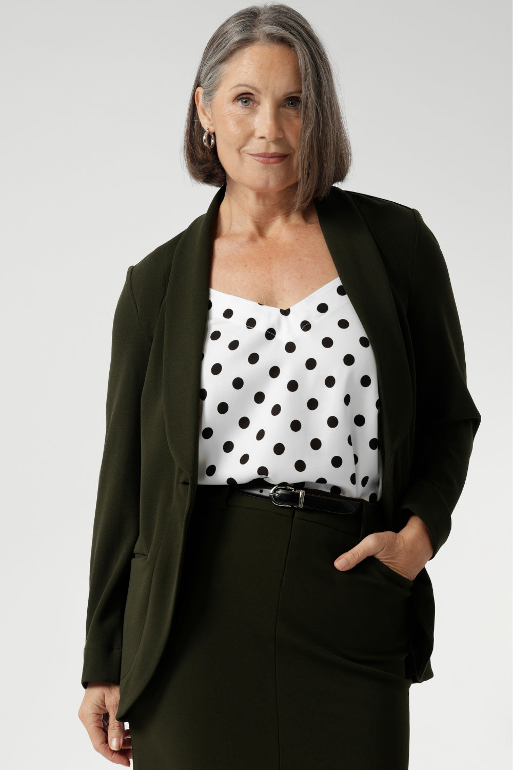 Woman's blazer will have you looking stylish in all corporate and casual occasions. Woman's workwear clothing made in Australia sizes 8-24. Size 10 woman wears her Olive Blazer with matching workwear midi skirt & polka dot cami.