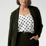 Woman's blazer will have you looking stylish in all corporate and casual occasions. Woman's workwear clothing made in Australia sizes 8-24. Size 10 woman wears her Olive Blazer with matching workwear midi skirt & polka dot cami.