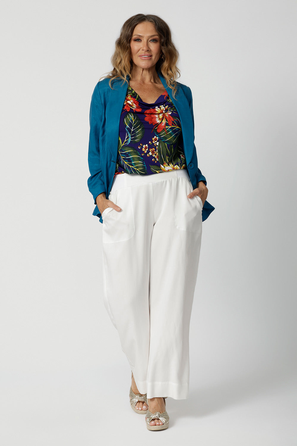 Top for summer worn by 40 year old woman, has been designed to breathable and perfect for travel. Easy-care and crease-resistant top is made of slinky jersey. Leina & Fleur is a womans clothing brand that have sizes from 8-24. Shop this summer ready top as it is lightweight and packable, fits easily in your suitcase for your travel adventures.