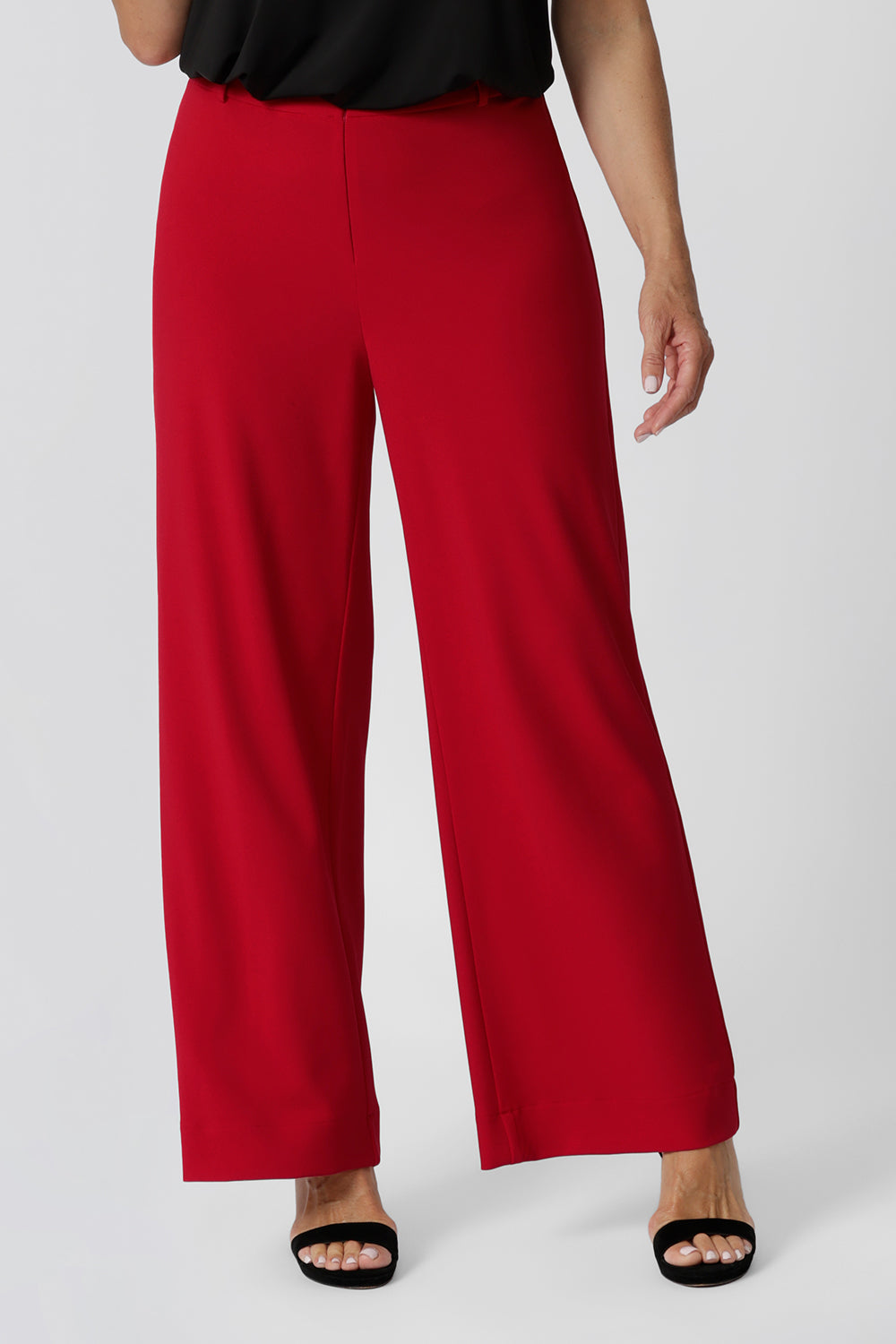 Close up of good pants for over 40s women, the Drew pant in red is a high waist pant with wide legs. Tailored belt loops and wide leg. Made in Australia for by Australian fashion label, L&F. Stylish corporate wear for women. Made in Australia size 8 - 24.