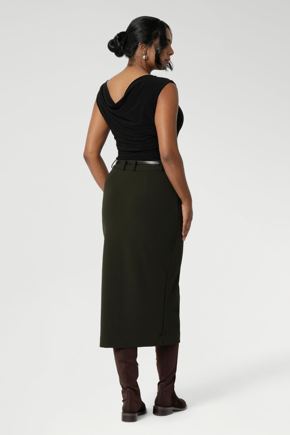 Australian made Olive workwear skirt seen on over 30's woman paired with black boat neck top and brown boots for an elevated workwear look. Sizes 8-24 available at Leina & Fleur.