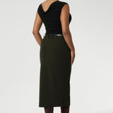 Australian made Olive workwear skirt seen on over 30's woman paired with black boat neck top and brown boots for an elevated workwear look. Sizes 8-24 available at Leina & Fleur.