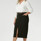 Plus size woman wears Australian made Olive workwear skirt seen on plus size woman paired with white blouse and brown kitten heels for an elevated workwear look. Sizes 8-24 available at Leina & Fleur.