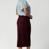 Back darts enhance the skirt’s shape, providing a tailored silhouette. The midi-length design offers a modern and flattering fit, making it a perfect choice for professional or dressy occasions.