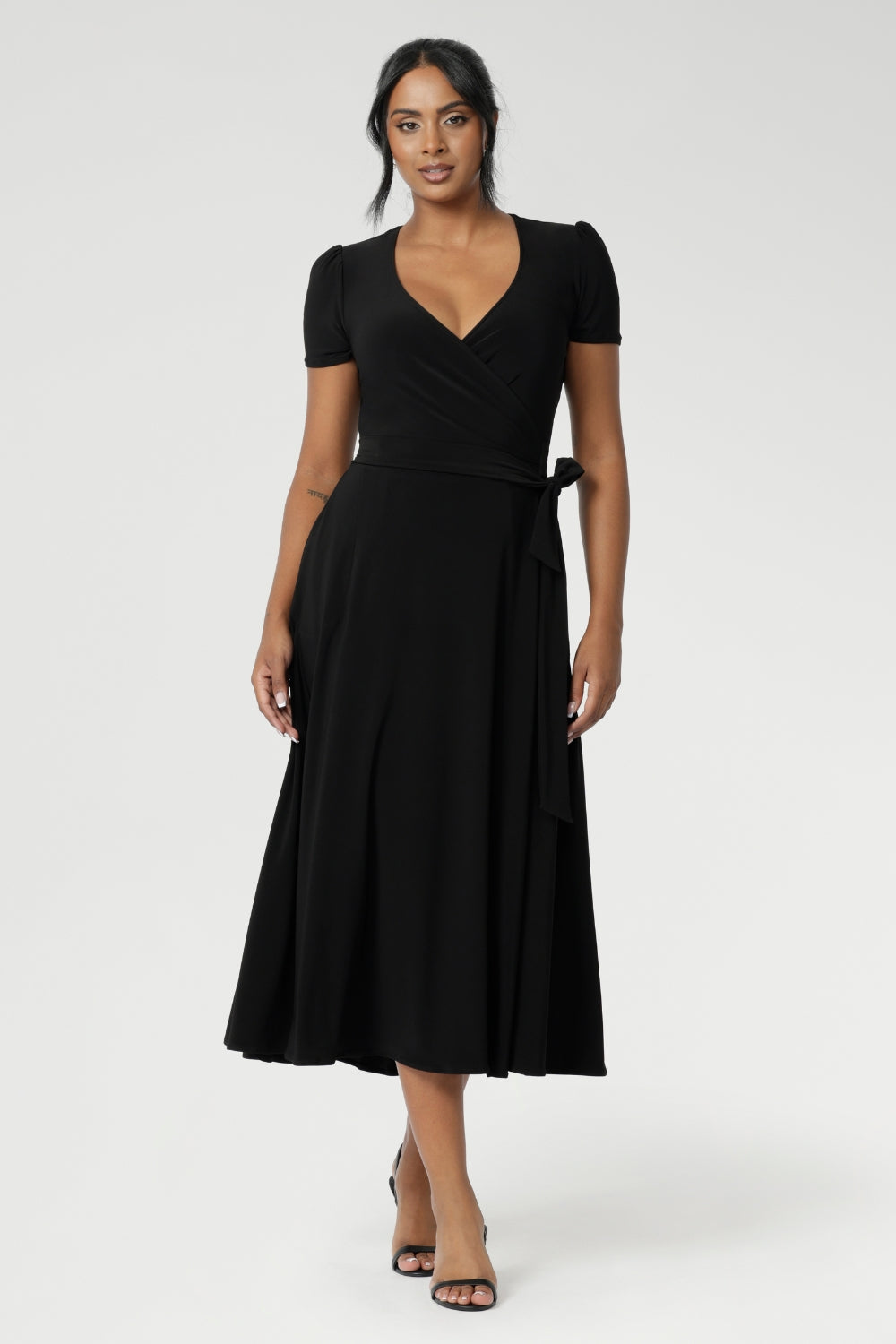 Size 10 woman wears short sleeved dress with tucks at the sleeveheads that adds a touch of detail, while the A-line skirt enhances its feminine silhouette. Available in size 8-24.