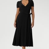 Size 10 woman wears short sleeved dress with tucks at the sleeveheads that adds a touch of detail, while the A-line skirt enhances its feminine silhouette. Available in size 8-24.