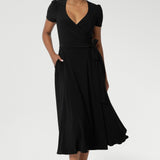 The Alexis dress is often described as the "perfect wrap dress" by many in the L&F community, seamlessly transitioning from work to event and weekend style. Crafted from a black dry-touch jersey fabric with a soft stretch, the Alexis dress offers both comfort and versatility.