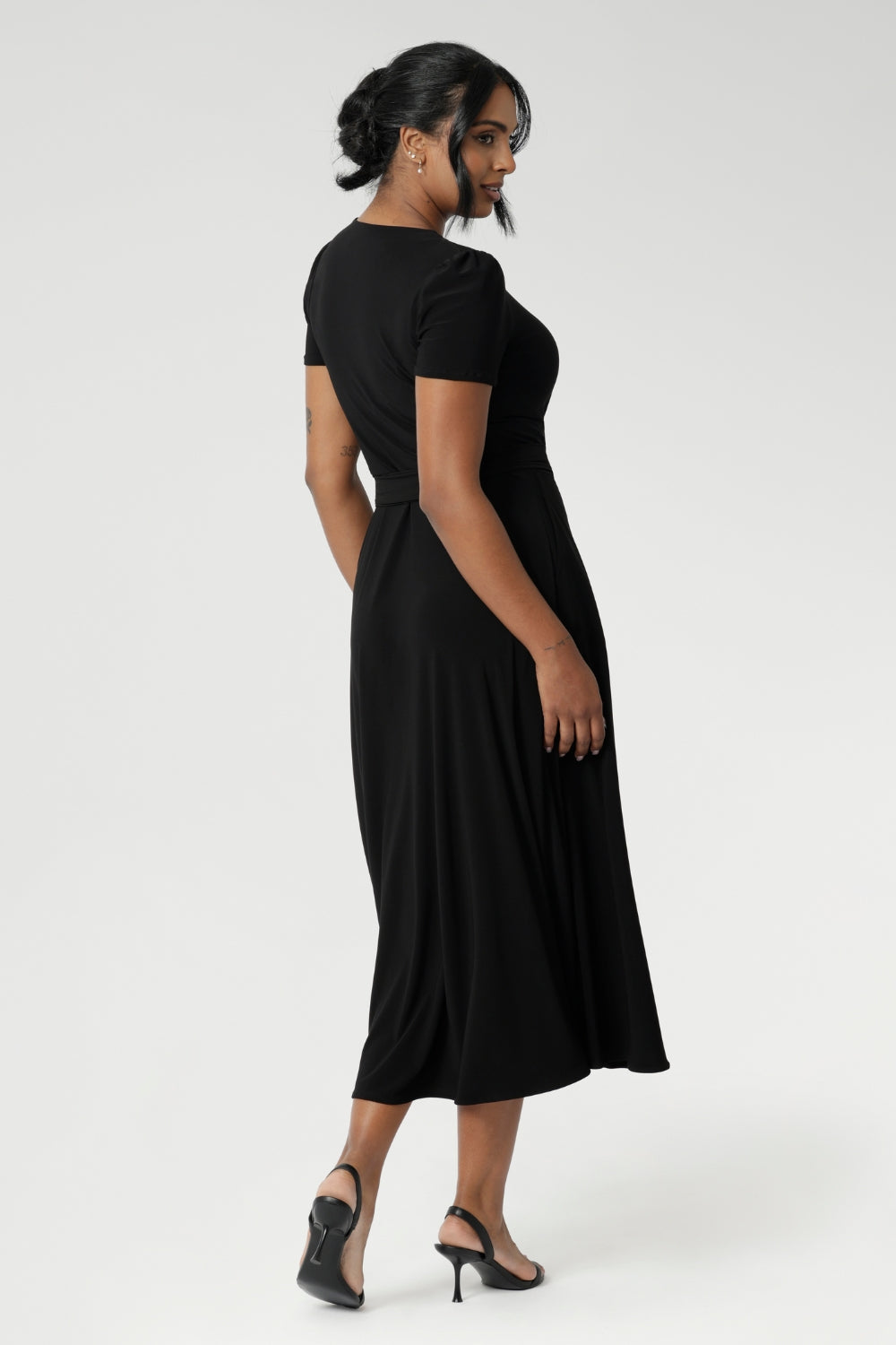 The functioning wrap design features an elegant double-layer back bodice and extended waist ties for a flattering fit.