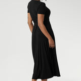 The functioning wrap design features an elegant double-layer back bodice and extended waist ties for a flattering fit.