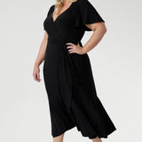 Elegant slinky black wrap dress with flutter sleeves, ruched bodice, and flowing ruffle skirt, Alita by L+F.