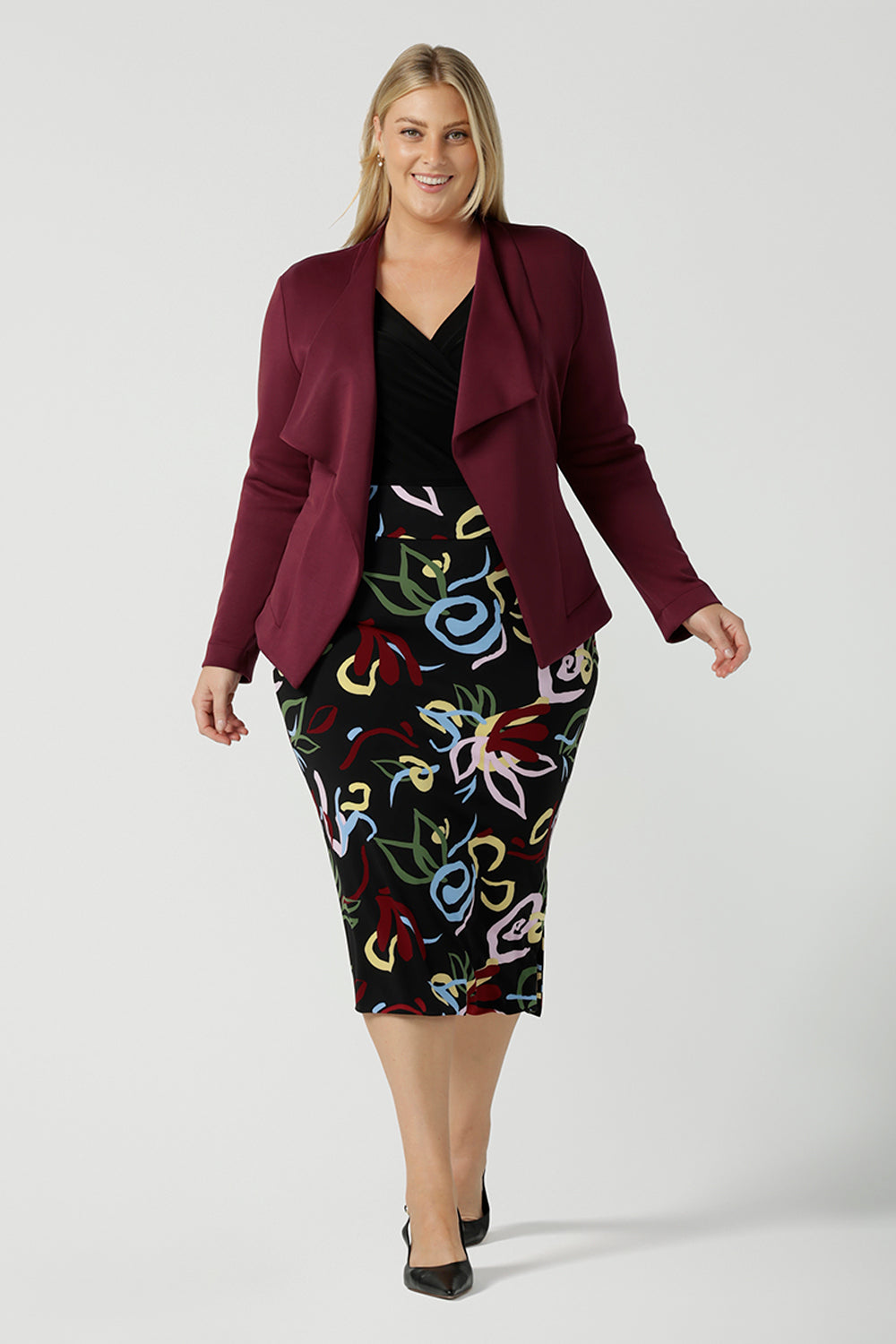 A size 18 woman wears the Lyndon Jacket Midi Skirt back with the Lyndon Jacket in wine.  Made in Australia for women size 8 - 24.