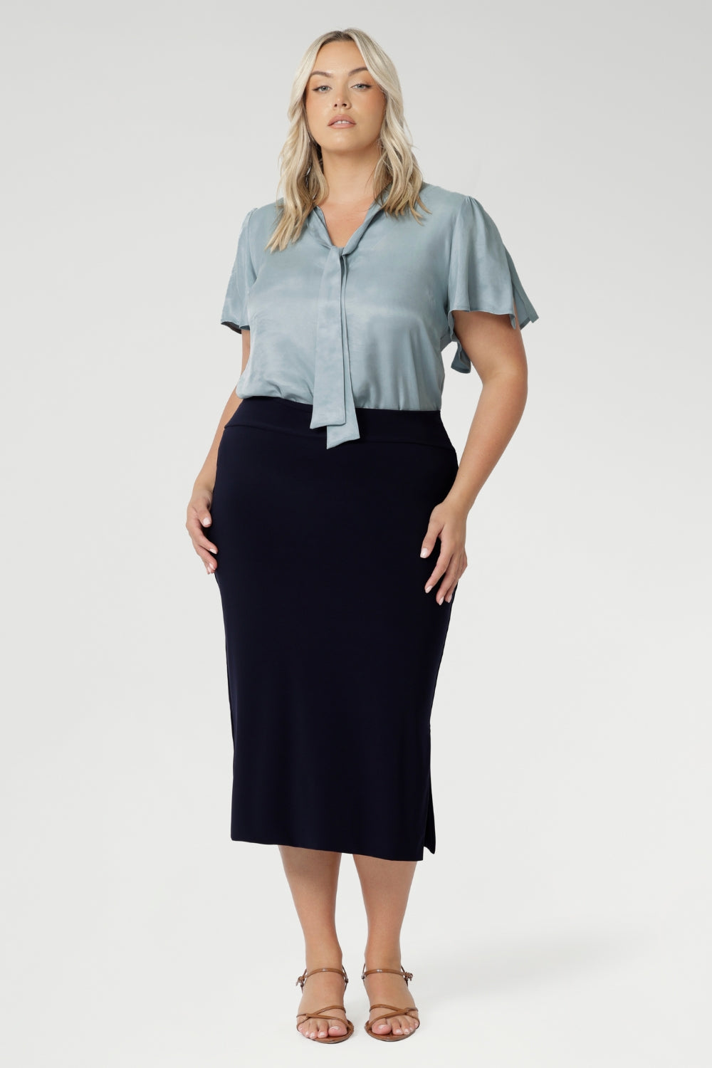 Elevate your wardrobe with the sophisticated Andi Midi Skirt in Navy, designed to keep you both work- and event-ready. Crafted from a navy dry-touch jersey fabric, this skirt offers a soft stretch for all-day comfort. The double-layered tube design includes a stylish side split for added movement and flair, while the soft folded waistband ensures a smooth, comfortable fit. Featuring a convenient pull-on style, the Andi Midi Skirt is cut to a flattering mid-calf length, making it a versatile addition to any