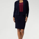 The Andi Tube Skirt is available in a mini, regular and midi length for a bold and stylish look no matter your style. Size 10 woman wears her navy tube skirt with matching jacardi in navy & ruby Top.