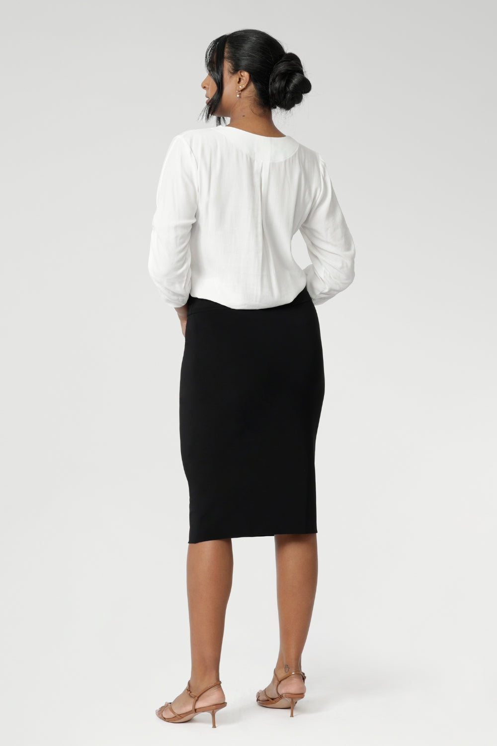 Now available in three lengths, this skirt is crafted from a black dry-touch jersey fabric with a soft stretch for ultimate comfort. Featuring a double-layer tube design, a soft folded waistband, and a convenient pull-on style, the Andi Tube Skirt offers a flattering regular length that pairs effortlessly with any wardrobe.