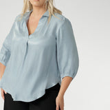 The Arley Shirt in Ice Blue offers a fresh take on everyday dressing with its clean, buttonless design and soft, suede-touch Tencel fabric. This pull-on style combines a sleek, contemporary silhouette with thoughtful detailing, making it a go-to piece for effortless polish.