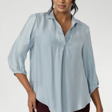 The Arley Shirt in Ice Blue offers a fresh take on everyday dressing with its clean, buttonless design and soft, suede-touch Tencel fabric. This pull-on style combines a sleek, contemporary silhouette with thoughtful detailing, making it a go-to piece for effortless polish.