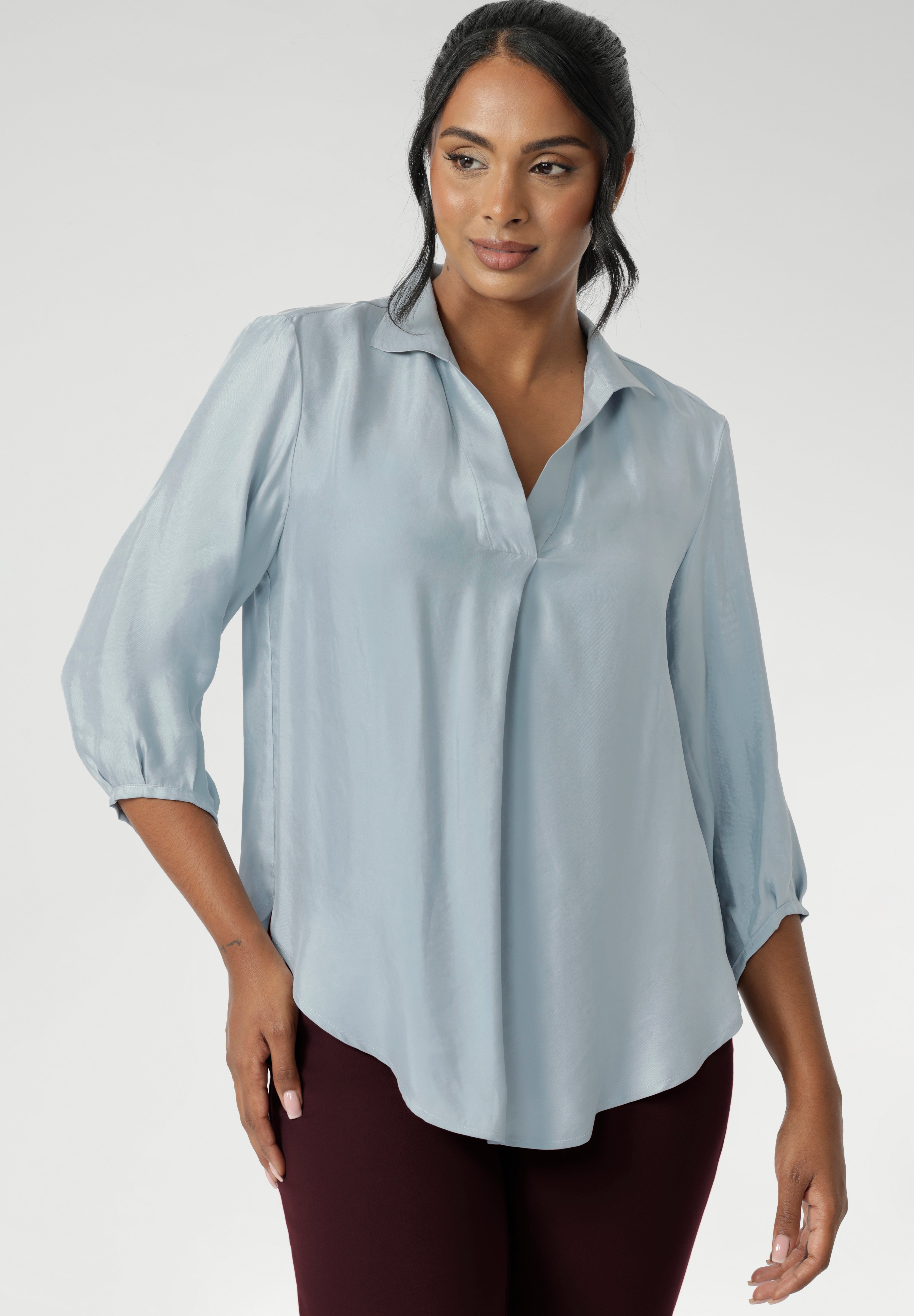 The Arley Shirt in Ice Blue offers a fresh take on everyday dressing with its clean, buttonless design and soft, suede-touch Tencel fabric. This pull-on style combines a sleek, contemporary silhouette with thoughtful detailing, making it a go-to piece for effortless polish.
