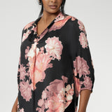 This elegant pull-on shirt offers a sophisticated yet comfortable style, perfect for everyday wear. Featuring a semi-fitted cut, it provides a flattering shape without being restrictive. The collar neckline adds a classic touch, while the subtle tuck details below the back neckline bring a refined, tailored look. Its 3/4 length soft sleeves are finished with narrow, bound hems for a neat, polished finish. Available in sizes 8-24.