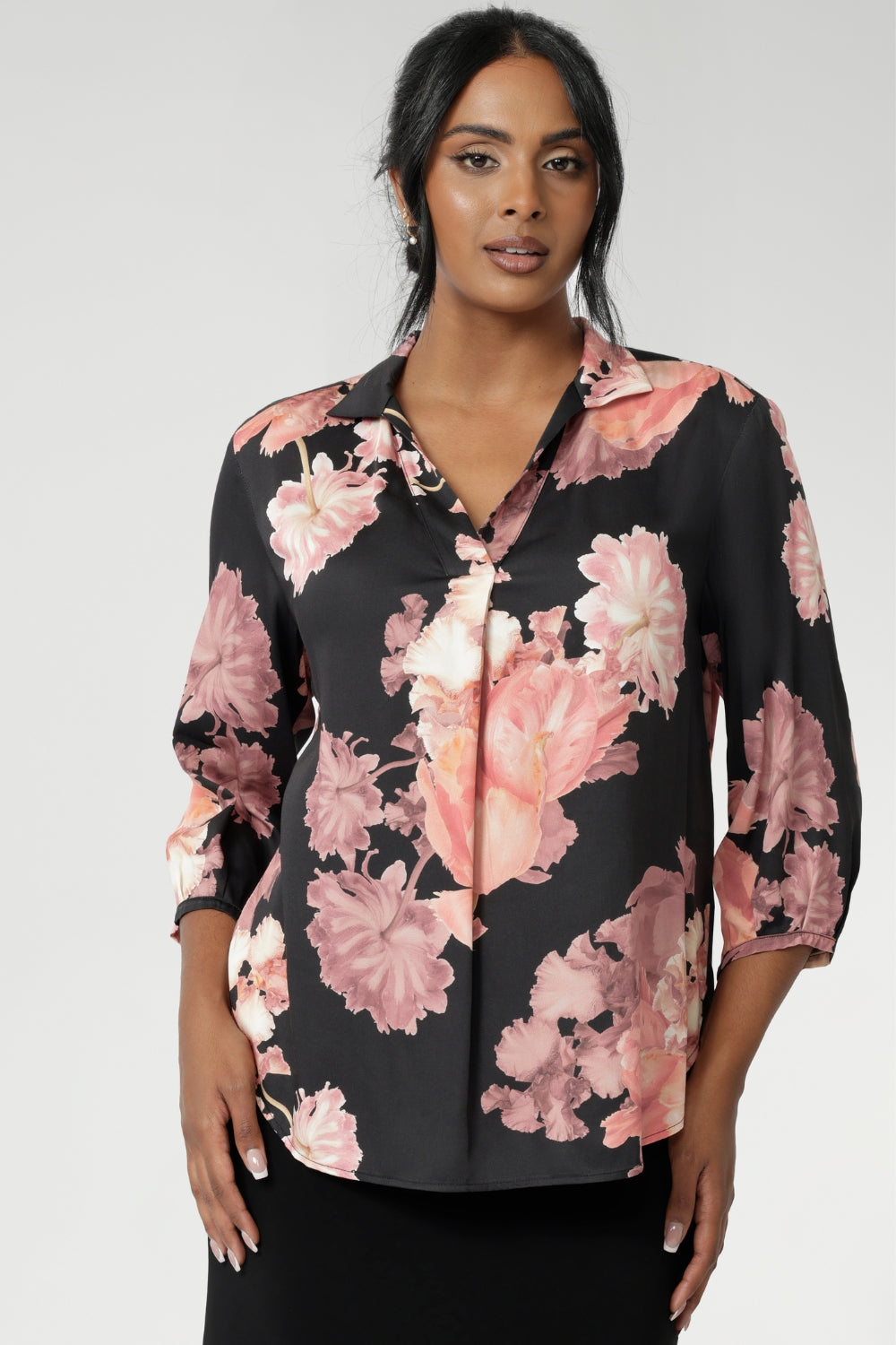 This elegant pull-on shirt offers a sophisticated yet comfortable style, perfect for everyday wear. Featuring a semi-fitted cut, it provides a flattering shape without being restrictive. The collar neckline adds a classic touch, while the subtle tuck details below the back neckline bring a refined, tailored look. Its 3/4 length soft sleeves are finished with narrow, bound hems for a neat, polished finish. Available in sizes 8-24.