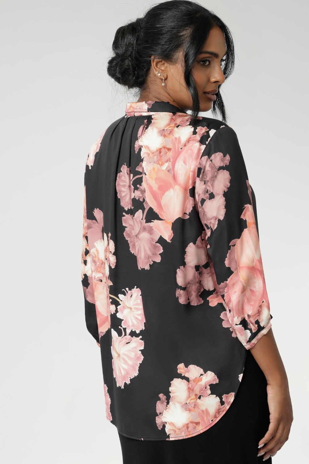 This elegant pull-on shirt offers a sophisticated yet comfortable style, perfect for everyday wear. Featuring a semi-fitted cut, it provides a flattering shape without being restrictive. The collar neckline adds a classic touch, while the subtle tuck details below the back neckline bring a refined, tailored look. Its 3/4 length soft sleeves are finished with narrow, bound hems for a neat, polished finish. Available in sizes 8-24.
