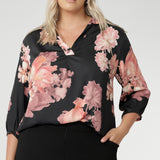 Plus size woman wears pull-on shirt that offers a sophisticated yet comfortable style, perfect for everyday wear. Featuring a semi-fitted cut, it provides a flattering shape without being restrictive. The collar neckline adds a classic touch, while the subtle tuck details below the back neckline bring a refined, tailored look. Its 3/4 length soft sleeves are finished with narrow, bound hems for a neat, polished finish. Available in sizes 8-24.