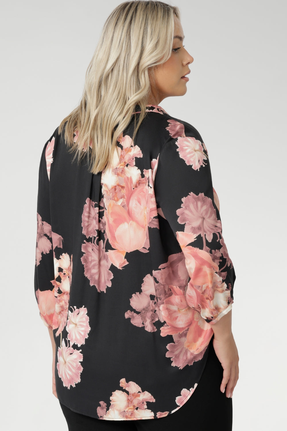 Plus size woman wears pull-on shirt that offers a sophisticated yet comfortable style, perfect for everyday wear. Featuring a semi-fitted cut, it provides a flattering shape without being restrictive. The collar neckline adds a classic touch, while the subtle tuck details below the back neckline bring a refined, tailored look. Its 3/4 length soft sleeves are finished with narrow, bound hems for a neat, polished finish. Available in sizes 8-24.