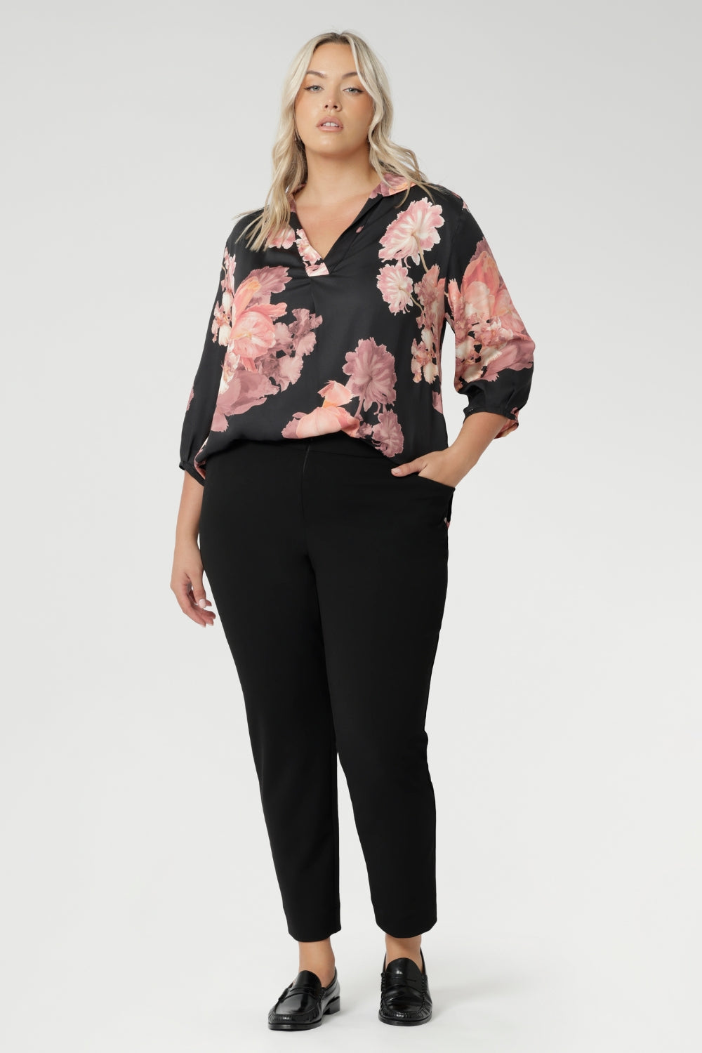 Plus size woman wears pull-on shirt that offers a sophisticated yet comfortable style, perfect for everyday wear. Featuring a semi-fitted cut, it provides a flattering shape without being restrictive. The collar neckline adds a classic touch, while the subtle tuck details below the back neckline bring a refined, tailored look. Its 3/4 length soft sleeves are finished with narrow, bound hems for a neat, polished finish. Available in sizes 8-24.