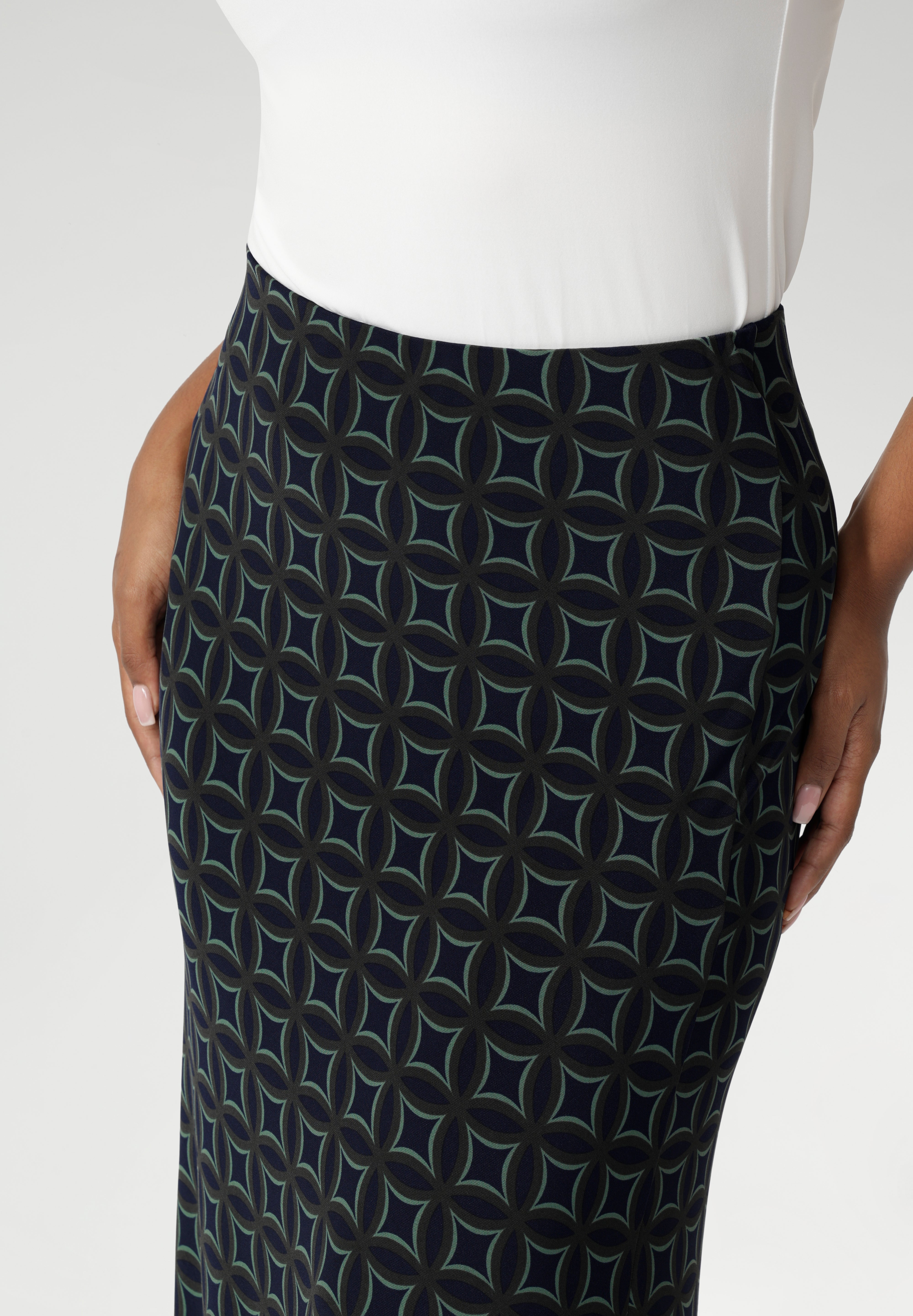 Made from printed navy dry-touch fabric that is easy care and comfortable. The bias-cut design of the skirt drapes beautifully, creating a flattering, fluid silhouette that moves with you. Available in sizes 8-24.
