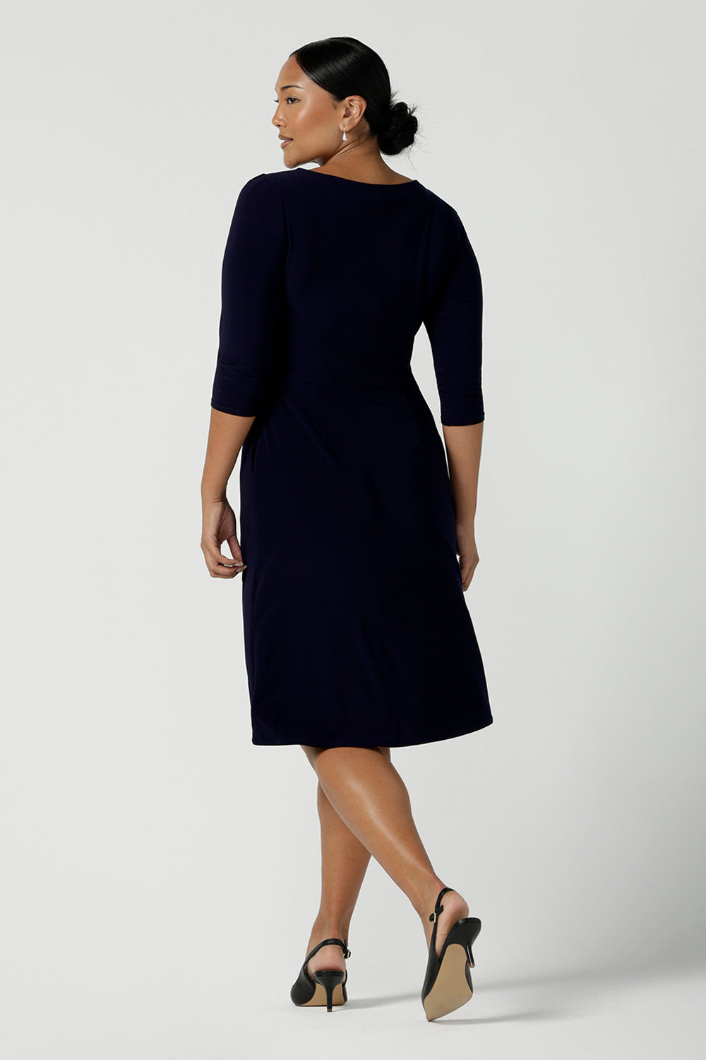 Back view of a size 10 woman wears the Audrey Shift Dress in Navy is the perfect all season shift dress. Soft jersey fabric, 3/4 sleeves and pockets. Made in Australia for women size 8 - 24.