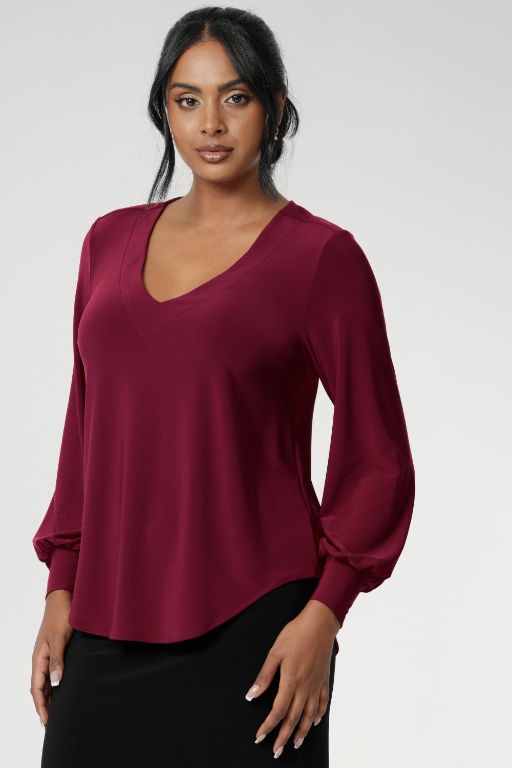 The Avery Top in Ruby brings effortless elegance to your everyday wardrobe, combining tailored structure with luxurious comfort. Crafted in Australia from a soft-stretch, dry-touch jersey fabric, this vibrant red women's top delivers both style and wearability. The semi-fitted silhouette features long bell sleeves with cuffs that add a touch of drama, while still maintaining a polished, versatile look.