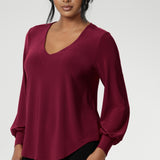 The Avery Top in Ruby brings effortless elegance to your everyday wardrobe, combining tailored structure with luxurious comfort. Crafted in Australia from a soft-stretch, dry-touch jersey fabric, this vibrant red women's top delivers both style and wearability. The semi-fitted silhouette features long bell sleeves with cuffs that add a touch of drama, while still maintaining a polished, versatile look.