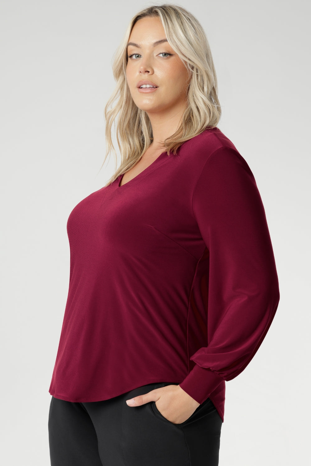 A flattering V-neckline and carefully placed bust darts enhance the feminine shape, making this top ideal for work, dinners, or stylish daywear. The back shoulder yoke is finished with gentle gathers, offering subtle movement and texture. The curved shirt-tail hemline flatters the hips when worn loose and maintains a chic, modern vibe if you prefer to French tuck. Available in inclusive sizes 8 to 24.
