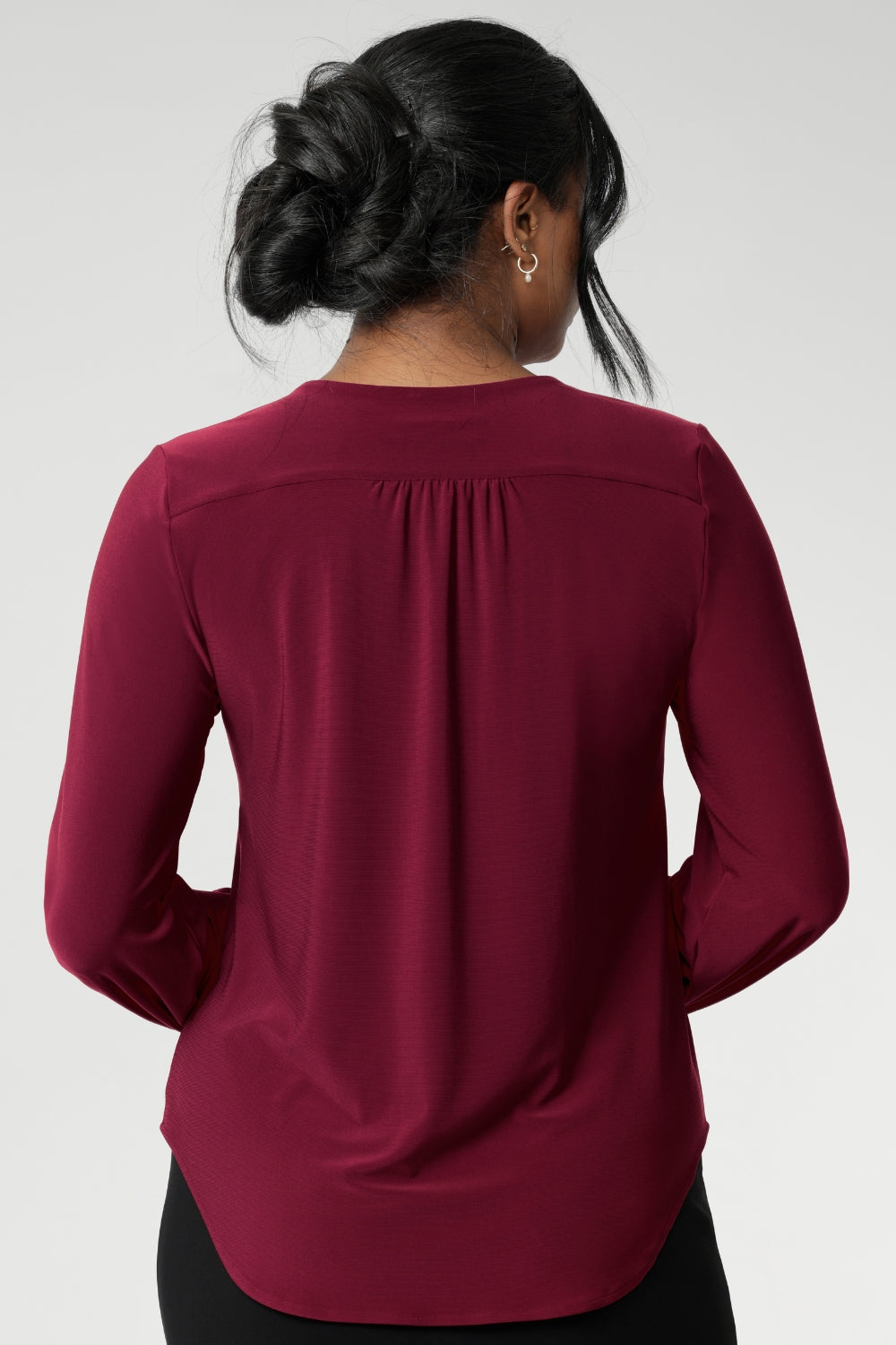 The semi-fitted silhouette features long bell sleeves with cuffs that add a touch of drama, while still maintaining a polished, versatile look. The curved shirt-tail hemline flatters the hips when worn loose and maintains a chic, modern vibe if you prefer to French tuck. Available in inclusive sizes 8 to 24