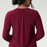 The semi-fitted silhouette features long bell sleeves with cuffs that add a touch of drama, while still maintaining a polished, versatile look. The curved shirt-tail hemline flatters the hips when worn loose and maintains a chic, modern vibe if you prefer to French tuck. Available in inclusive sizes 8 to 24
