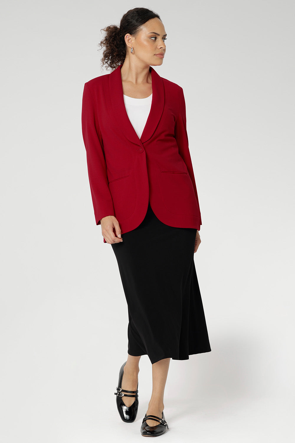 Bright red coloured blazer, a textured scuba crepe. Red work blazer is worn with black skirt and white t-shirt. Curved hemline and front pockets. This blazer is Made in Australia for petite women in sizes 8 - 24.