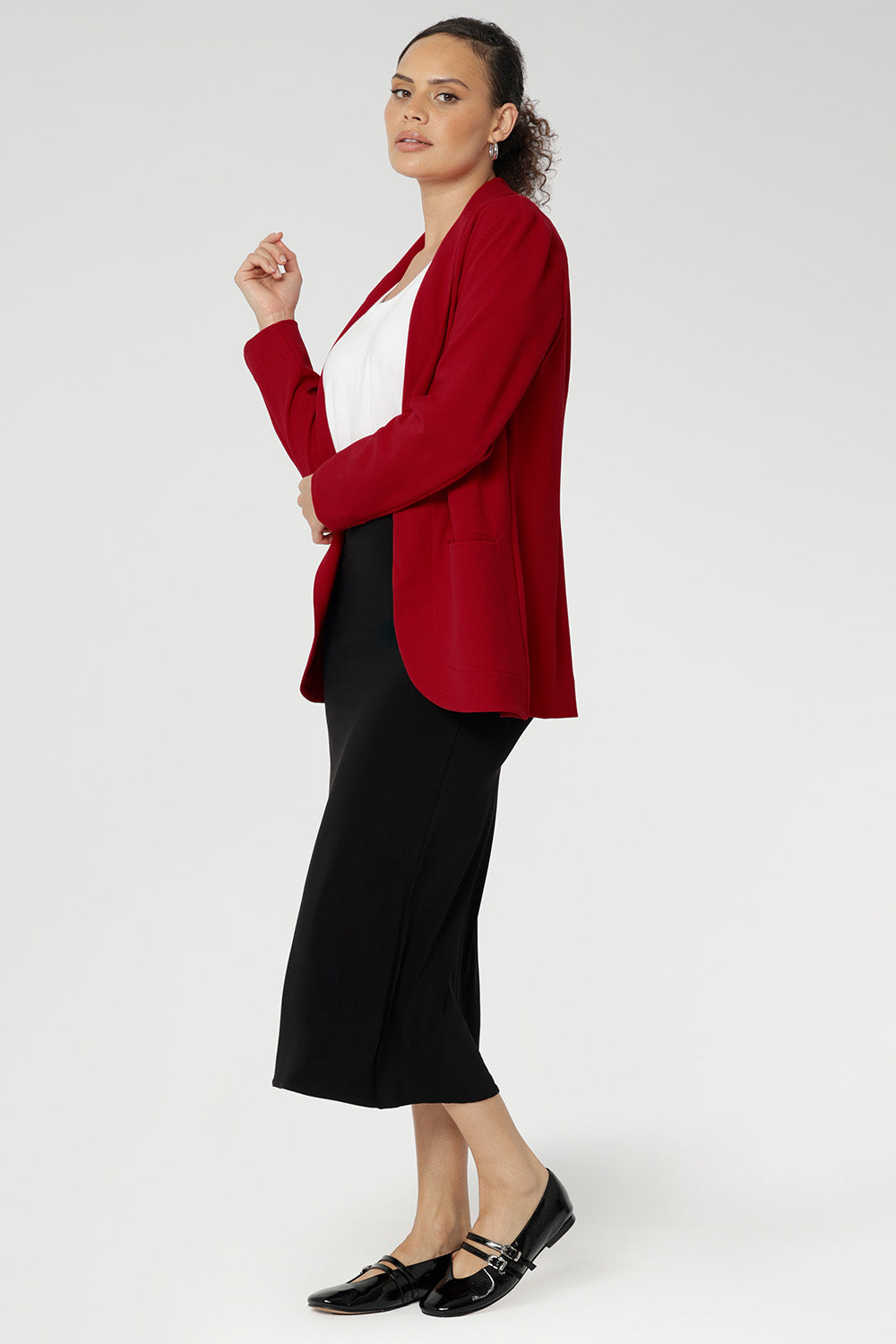 Bright red coloured blazer, a textured scuba crepe. Red work blazer is worn with black skirt and white t-shirt. Curved hemline and front pockets. This blazer is Made in Australia for petite women in sizes 8 - 24.