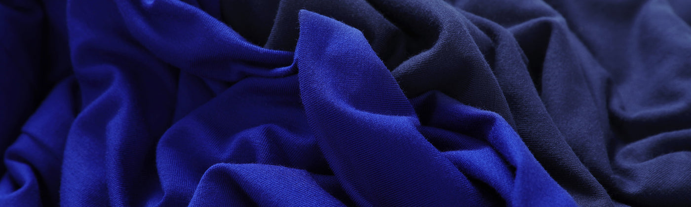 Cobalt blue and French navy bamboo jersey fabrics swirled together to show the qualities of the bamboo fabric used by Australian fashion brand, Leina & Fleur to make a range of lightweight, breathable tops for women. 