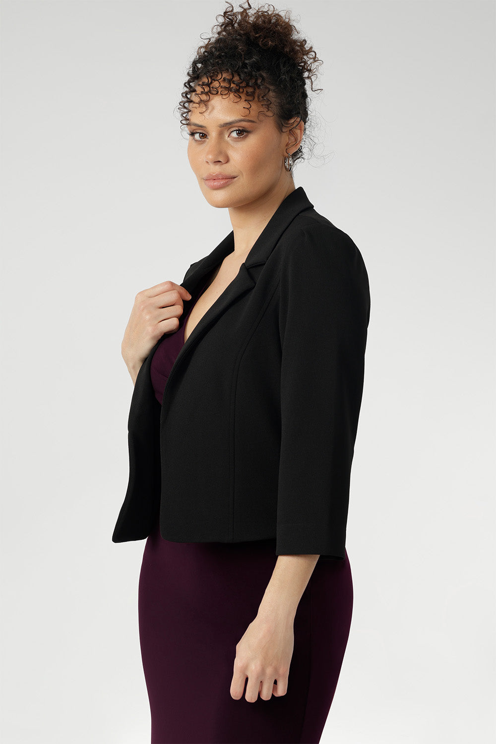 The single-layer back is shaped with delicate darts that contour the figure, while the shoulder yoke adds a structured element to the overall design.