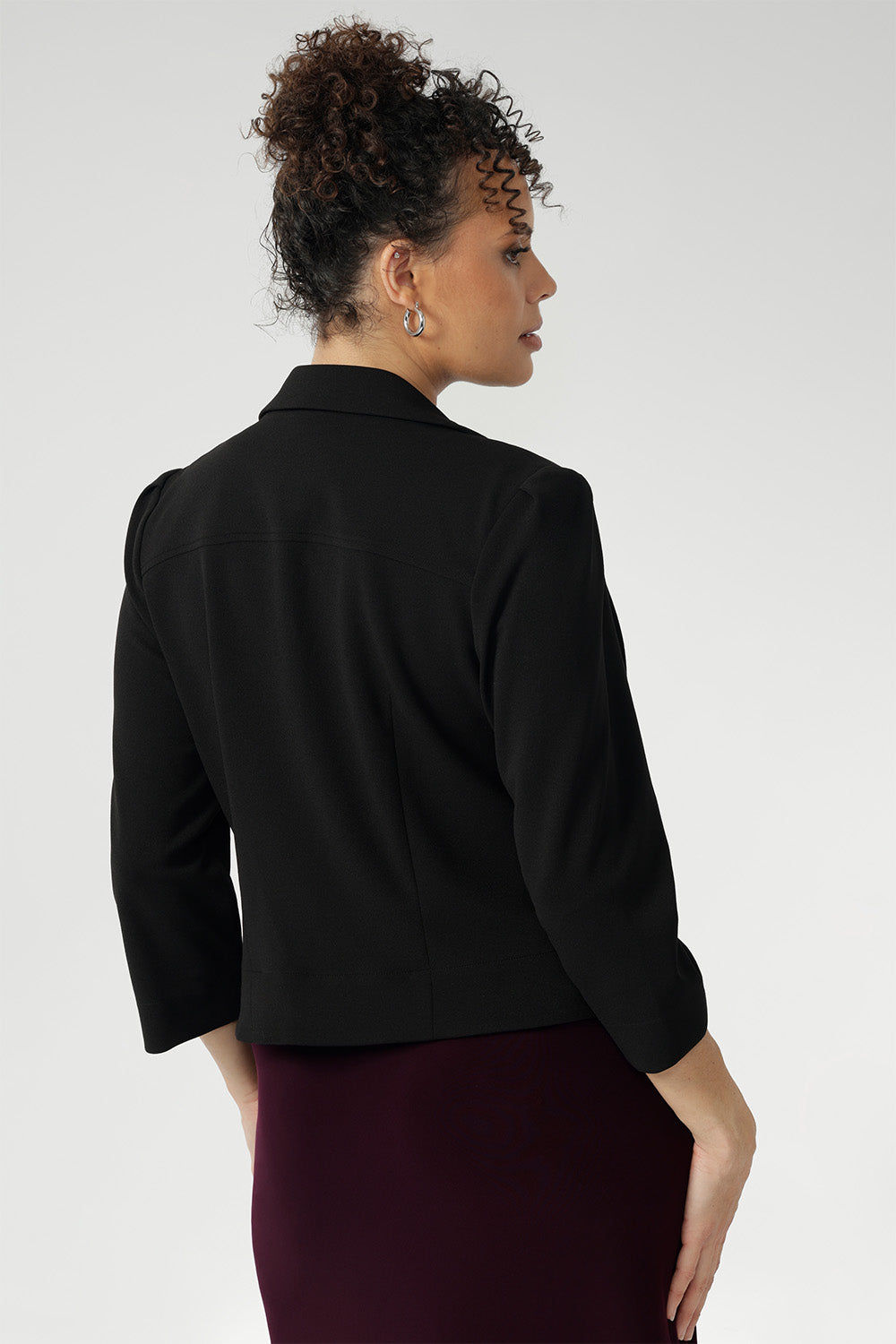 This black cropped jacket exudes sophisticated, modern tailoring, crafted from a luxe Scuba Crepe fabric. The fabric’s soft, textured feel and slight stretch provide both comfort and a flattering fit.