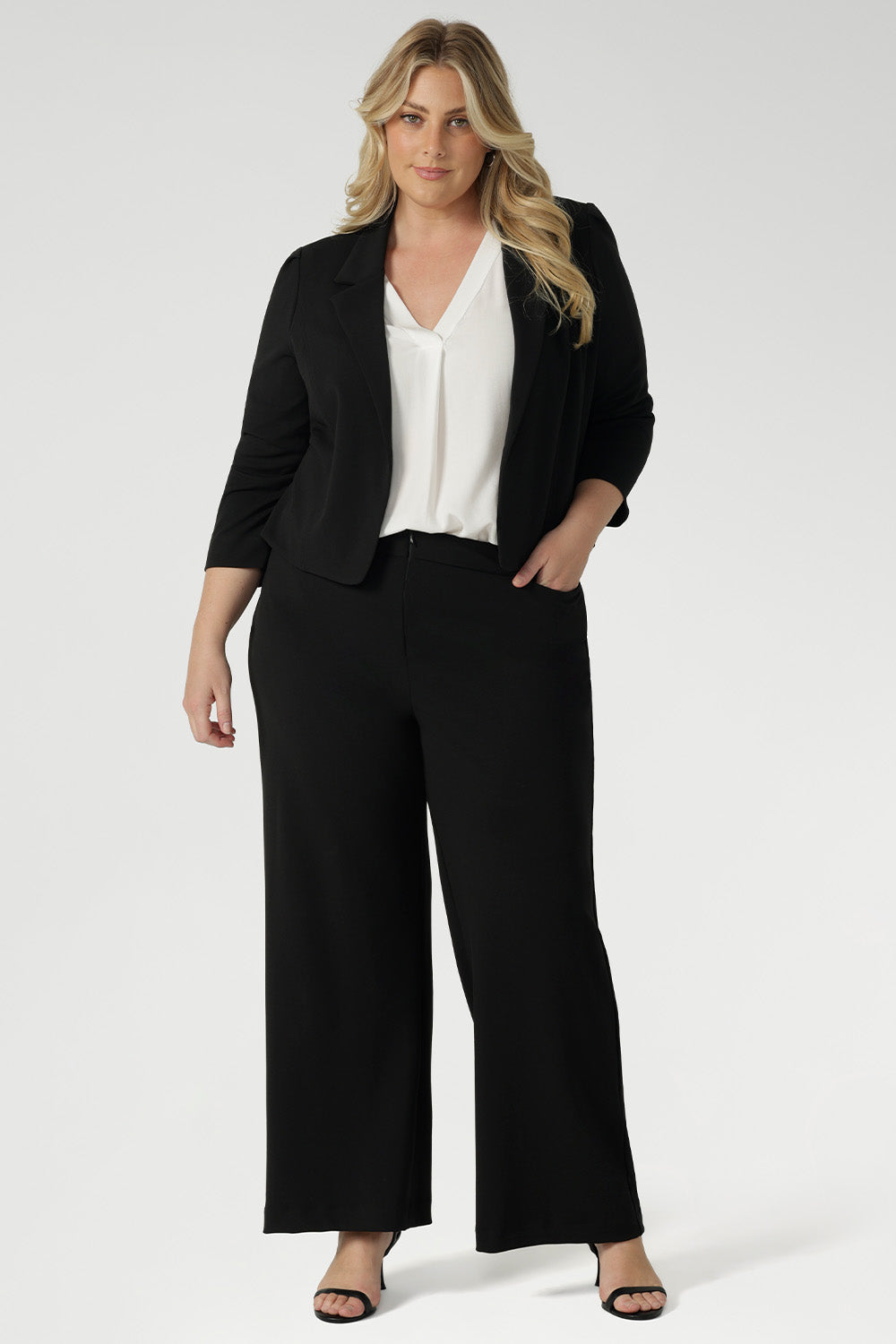 This black workwear cropped jacket exudes sophisticated, modern tailoring, crafted from a luxe Scuba Crepe fabric. The fabric’s soft, textured feel and slight stretch provide both comfort and a flattering fit.