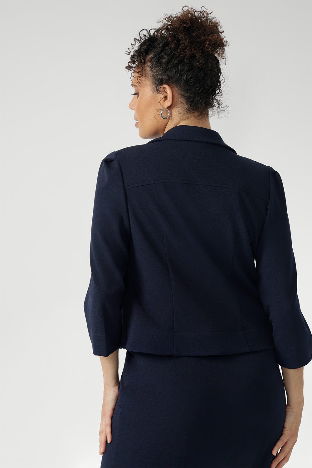 Navy workwear cropped jacket exudes sophisticated, modern tailoring, crafted from a luxe Scuba Crepe fabric. The fabric’s soft, textured feel and slight stretch provide both comfort and a flattering fit.