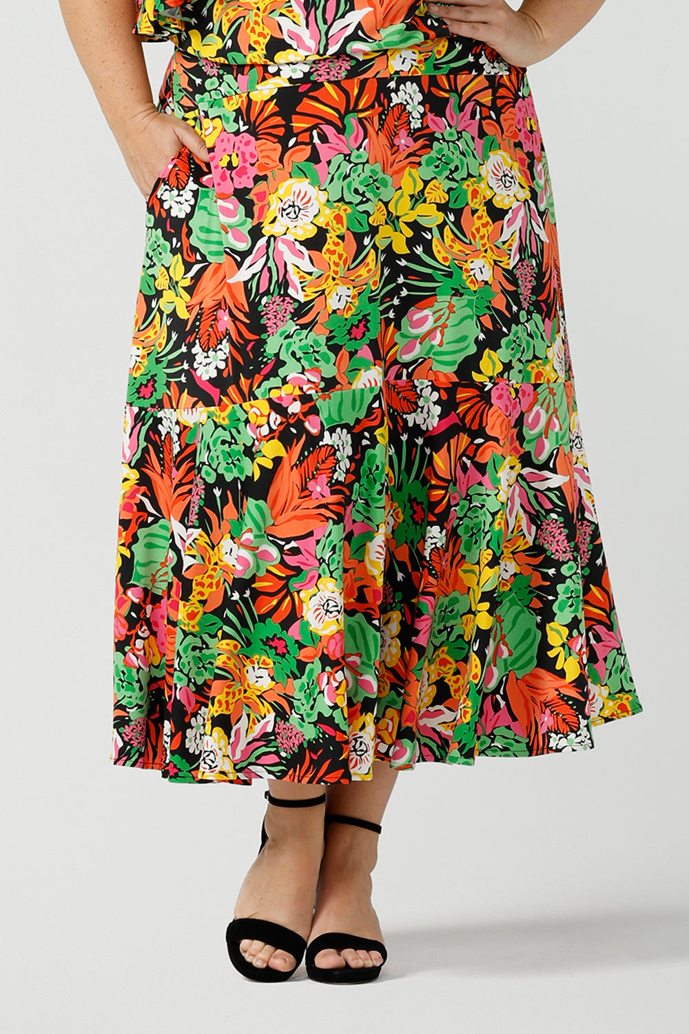 Close up of curvy woman wearing a colourful tiered skirt with off shoulder top. Beautiful Cancun print in multi-colour soft jersey. The perfect statement outfit for the summer season. Designed and made in Australia sizes 8-24.