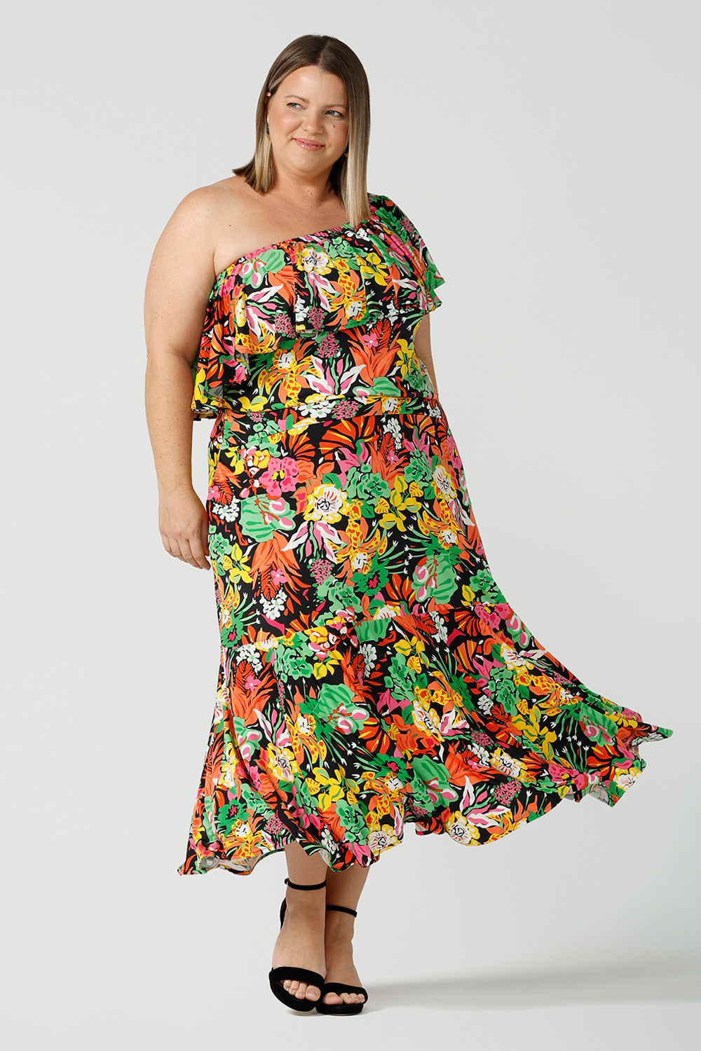 Plus size curvy woman wears colourful tiered skirt with off shoulder top. Beautiful Cancun print in multi-colour soft jersey. The perfect statement outfit for the summer season. Designed and made in Australia sizes 8-24.