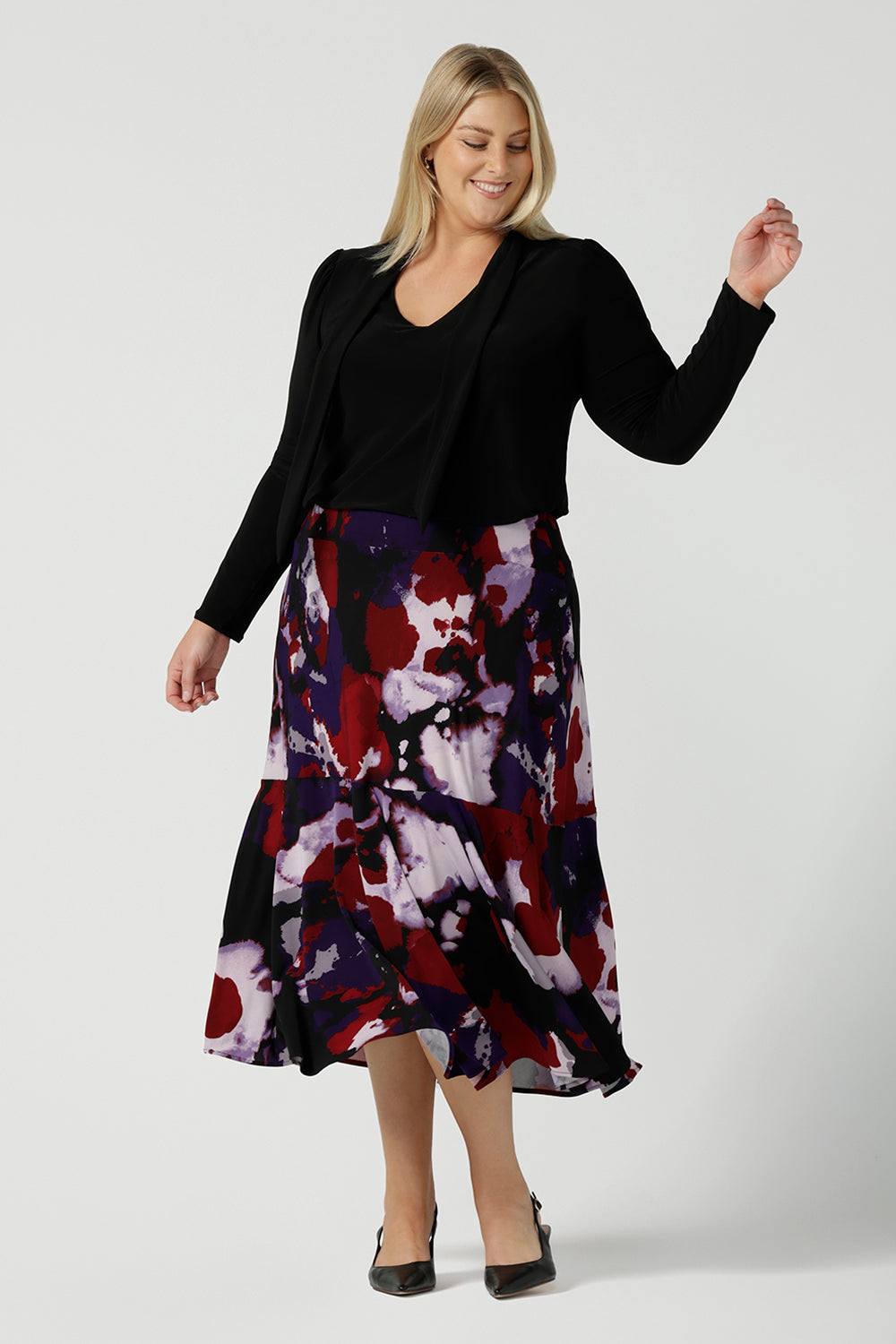 Size 18 woman wears the Berit Maxi skirt in the Fitzroy Print. Styled back with black pumps. Made in Australia for women size 8 - 24.