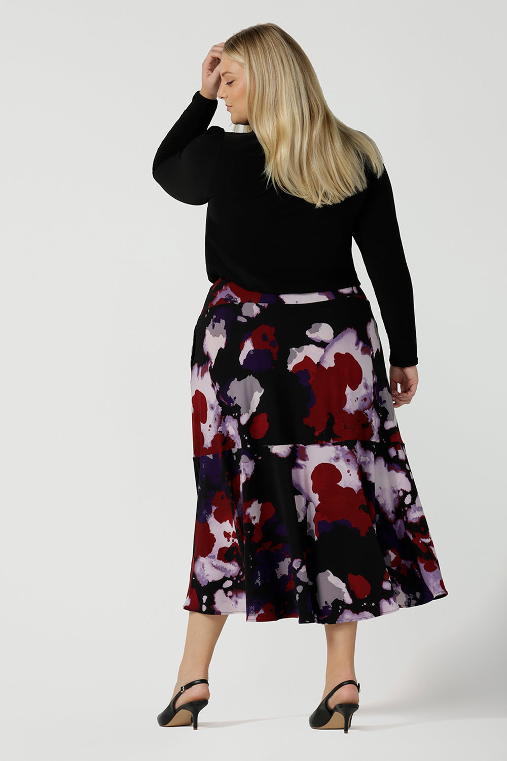 Back view of a size 18 woman wears the Berit Maxi skirt in the Fitzroy Print. Styled back with black pumps. Made in Australia for women size 8 - 24.