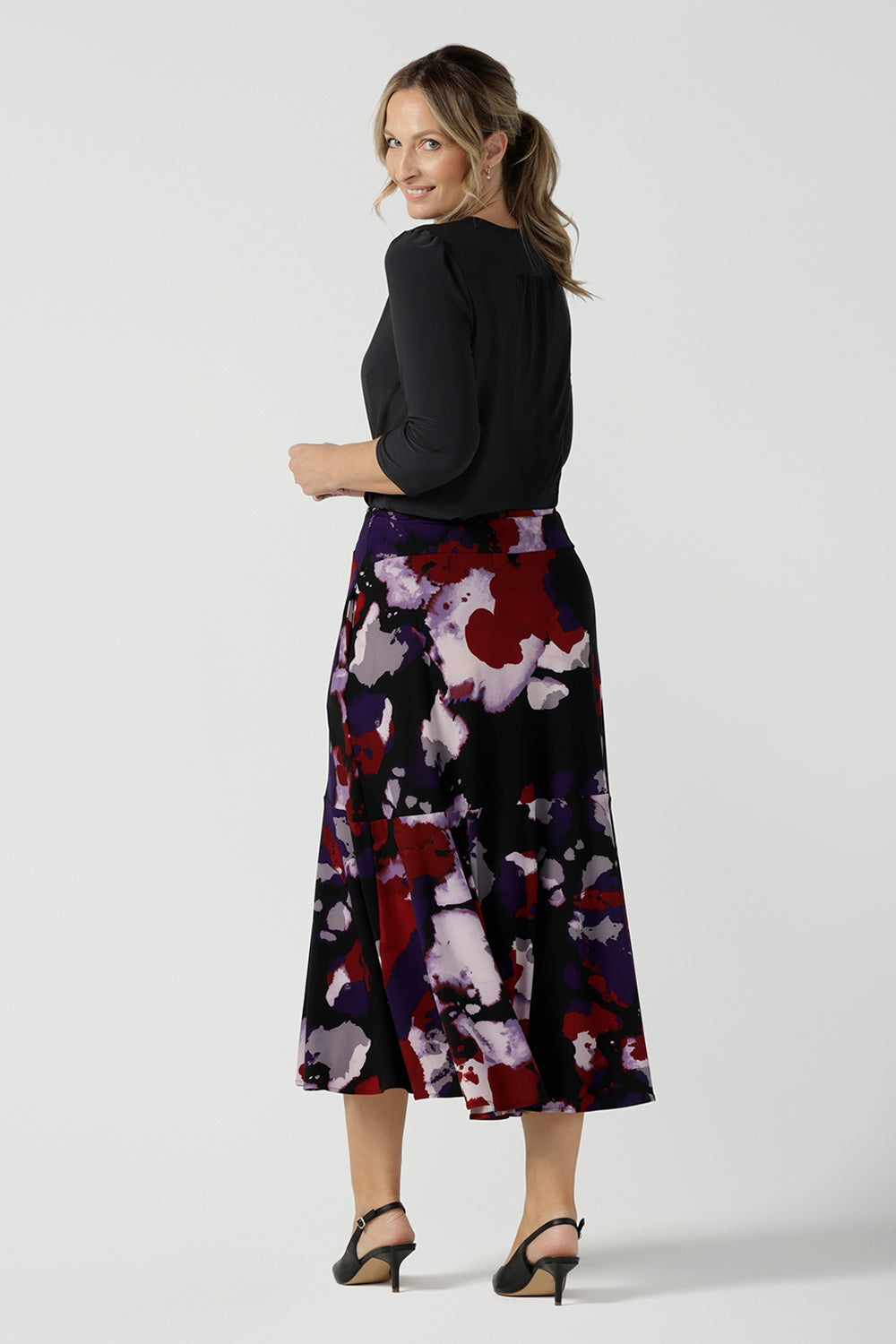 Back view of a size 10 woman wears the Berit Maxi skirt in the Fitzroy Print. Styled back with black pumps. Made in Australia for women size 8 - 24.